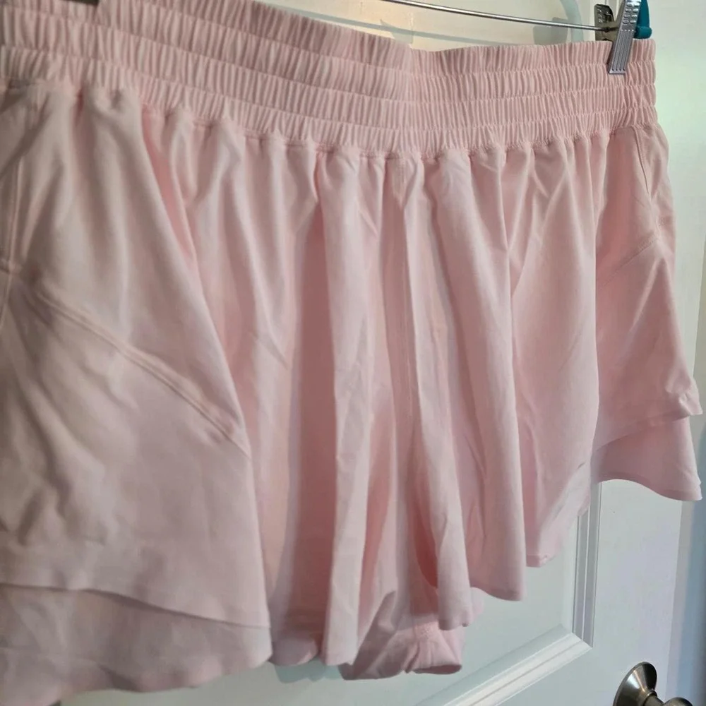 Lululemon Shake It Out High Rise Run Shorts in light baby pink pearl color